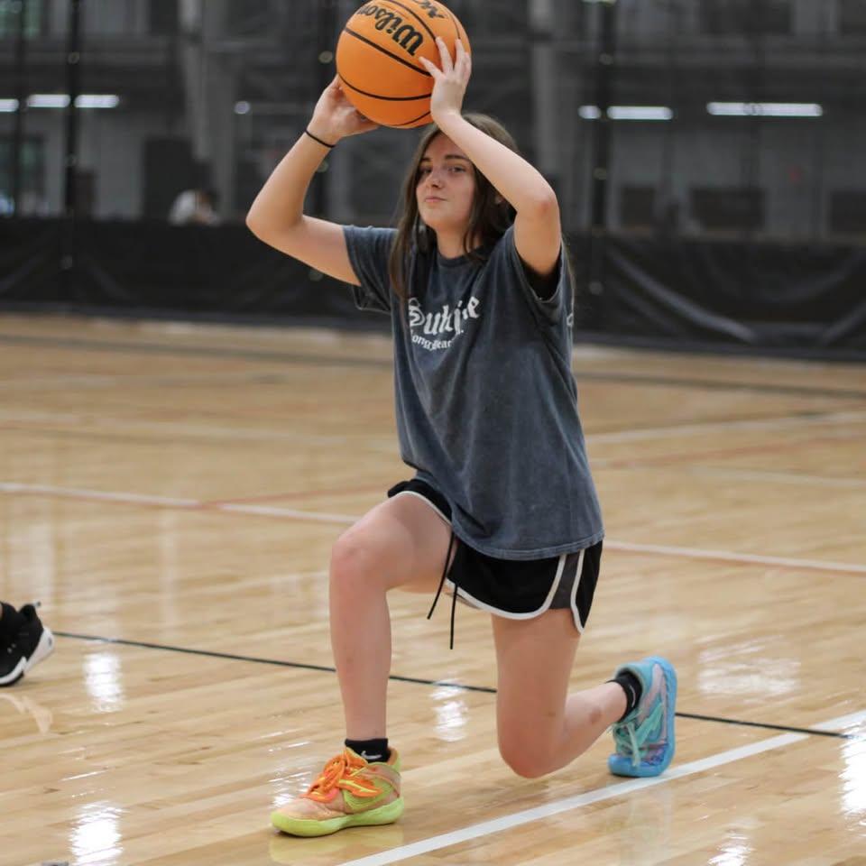A Team Elevate player sets up a jump shot on an indoor court.